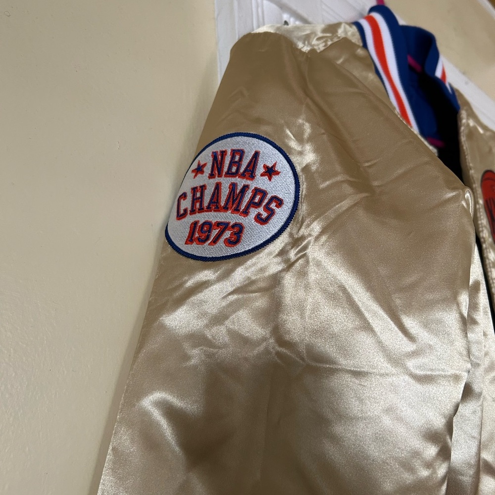 Gold men’s Mitchell and Ness New York Knicks Bomber jacket
